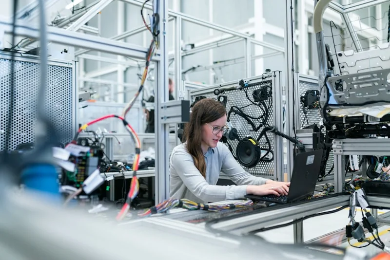 Industrial robotic work cell on factory floor — handling equipment